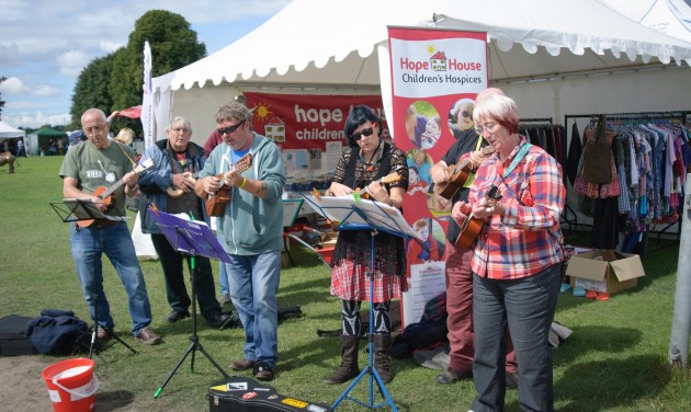 Ukelele players performing outside the Hope House stall at Shrewsbury Folk Festival 2014 - credit Mike Dean